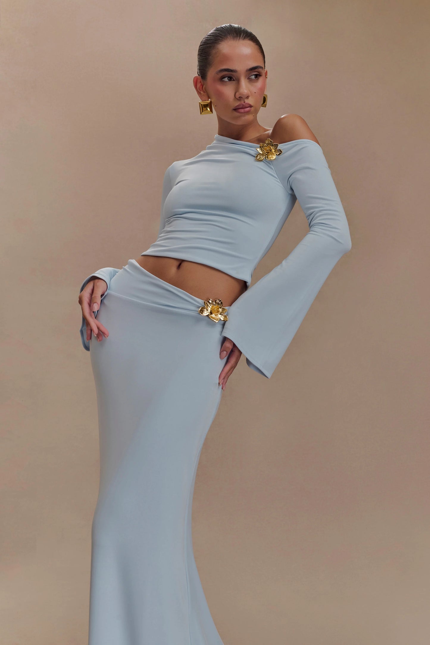 Ainsley Asymmetrical Long Sleeve Top With Floral Hardware - Pale Blue